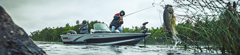 2017 two men fishing in their boat at a lake.